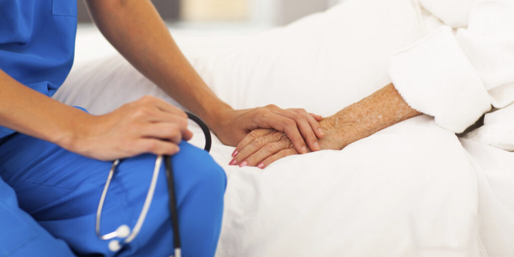 cure-palliative medical doctor comforting senior patient