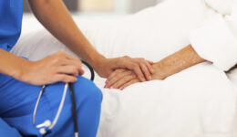 cure-palliative medical doctor comforting senior patient