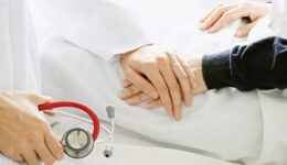 Medical doctor holding patient’s hands and comforting her with care, Doctor supports her palliative patient with sympathy. Medical doctor holding patient's hands and comforting her with care, Doctor supports her palliative patient with sympathy. (Selective Focus)