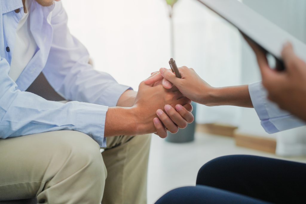 Men talk with a psychologist during talking therapy stressed men Men talk with a psychologist during talking therapy stressed mental health at office